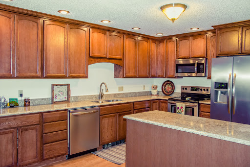 A beautifully designed modern kitchen featuring wooden cabinets, granite countertops, and stainless steel appliances.