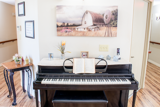A beautifully arranged piano scene featuring a sheet of music and artwork in the background.