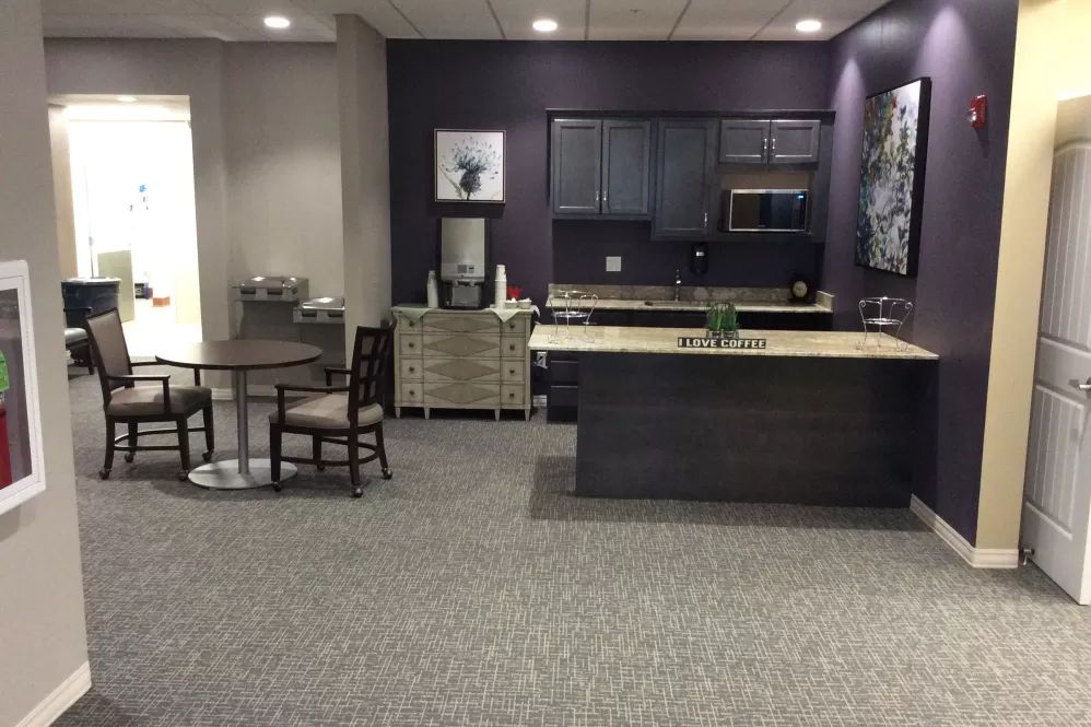 A modern kitchen interior with a dining area and contemporary furnishings.