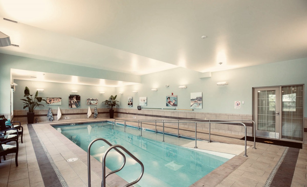 A tranquil indoor swimming pool with modern interior design, perfect for exercise and relaxation.