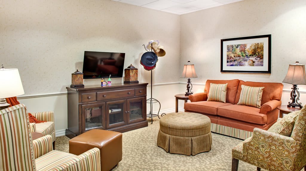 A cozy living room featuring a sofa, television, and stylish decor.