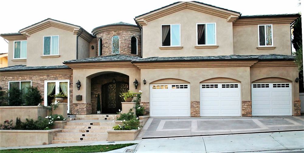 A luxury two-story house with a double garage and elegant entrance.