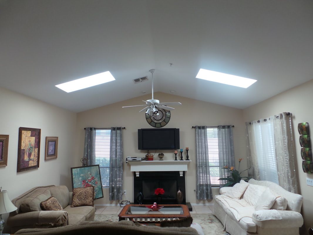 A cozy living room with a fireplace, television, and comfortable sofas.