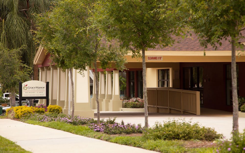 A scenic view of a building surrounded by trees and well-maintained landscaping.