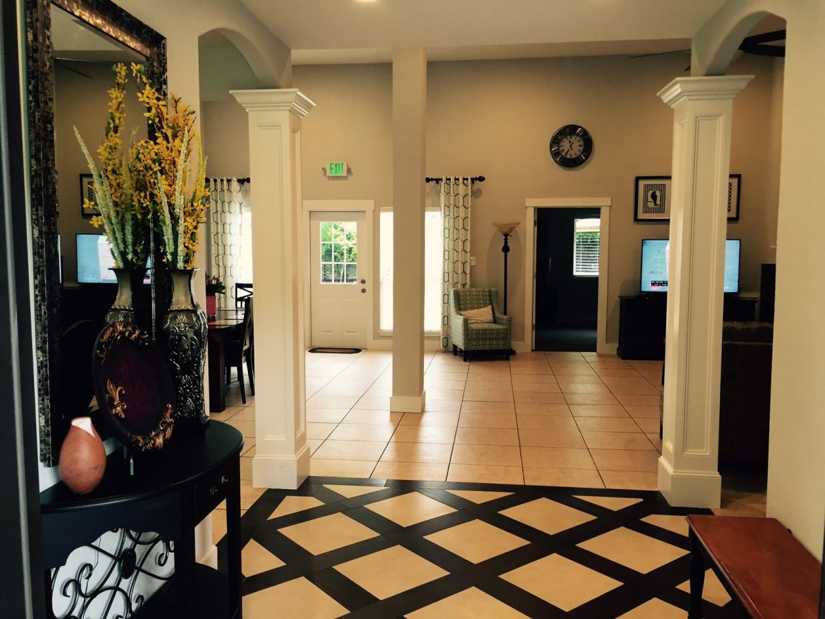 A welcoming lobby with elegant columns and decorative floor tiles.
