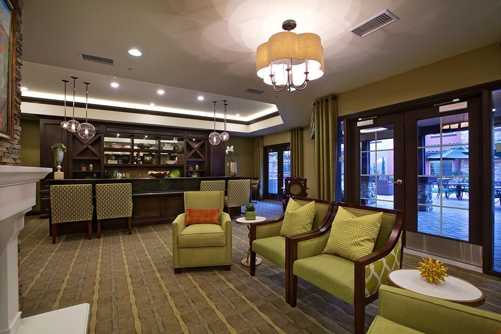 A stylish and cozy lounge with comfortable seating, elegant lighting, and a bar area.