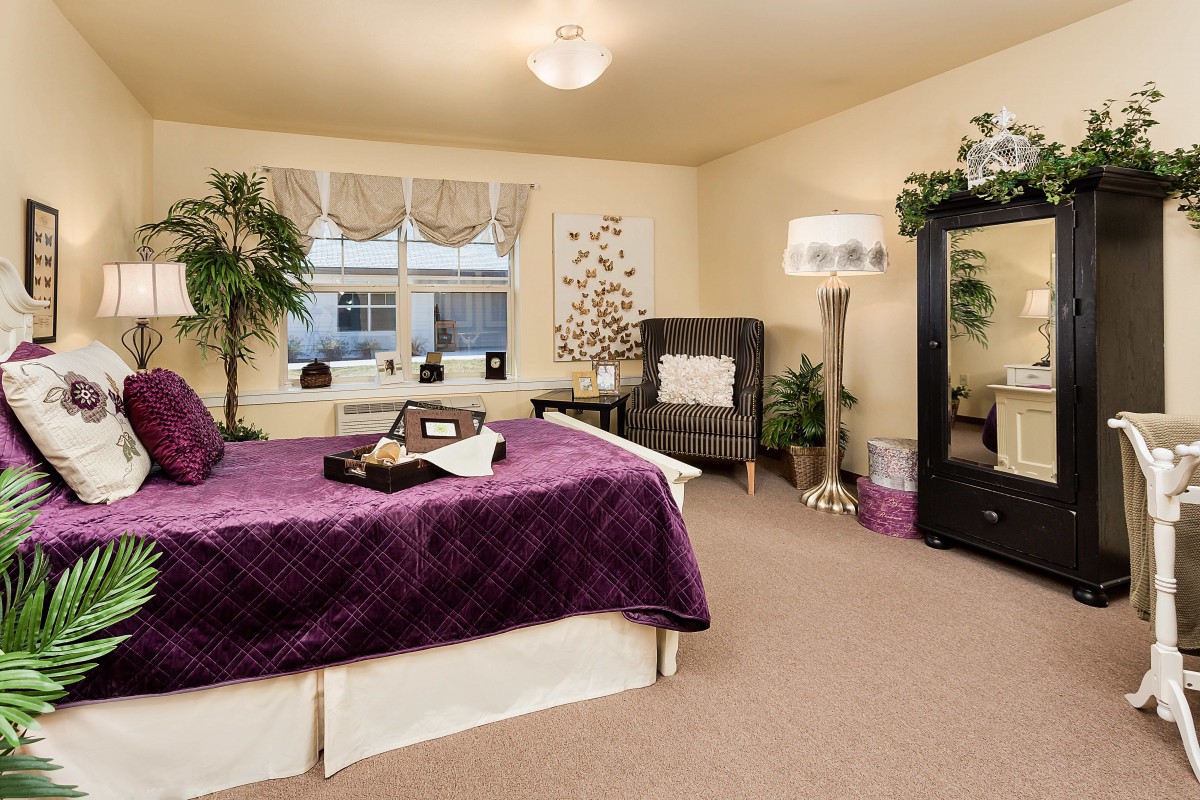 A cozy modern bedroom with elegant decor and indoor plants.