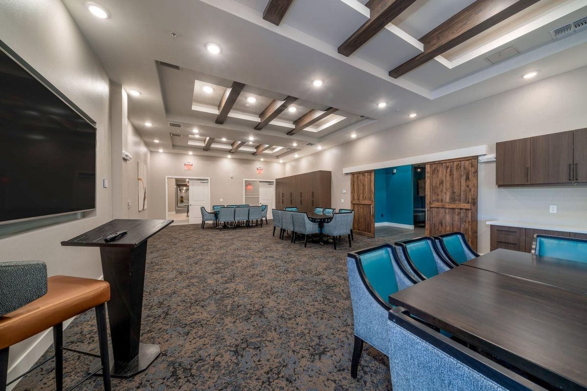 A modern conference room with a stylish interior, featuring comfortable seating and ample lighting.
