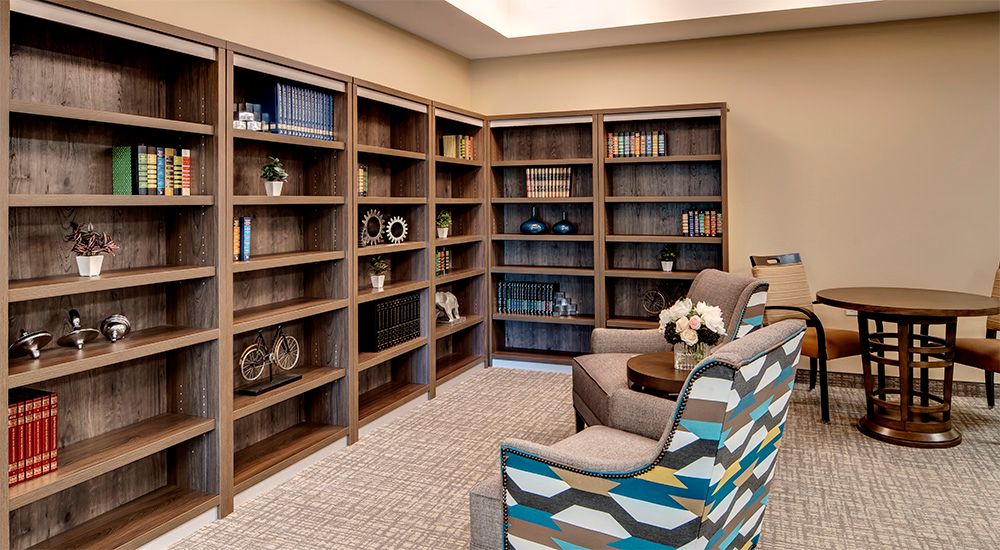 A cozy library corner with bookshelves and comfortable seating.
