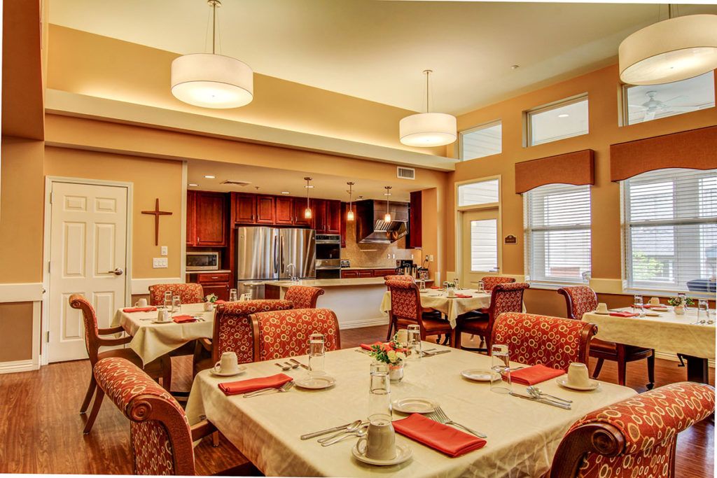 A cozy dining area with elegant table settings and a view of the kitchen.