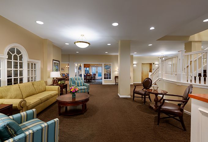 A well-lit lobby features comfortable seating and elegant decor.