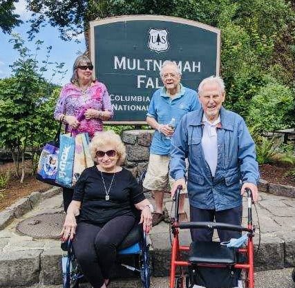 A group of seniors visiting Multnomah Falls, enjoying an outdoor excursion.