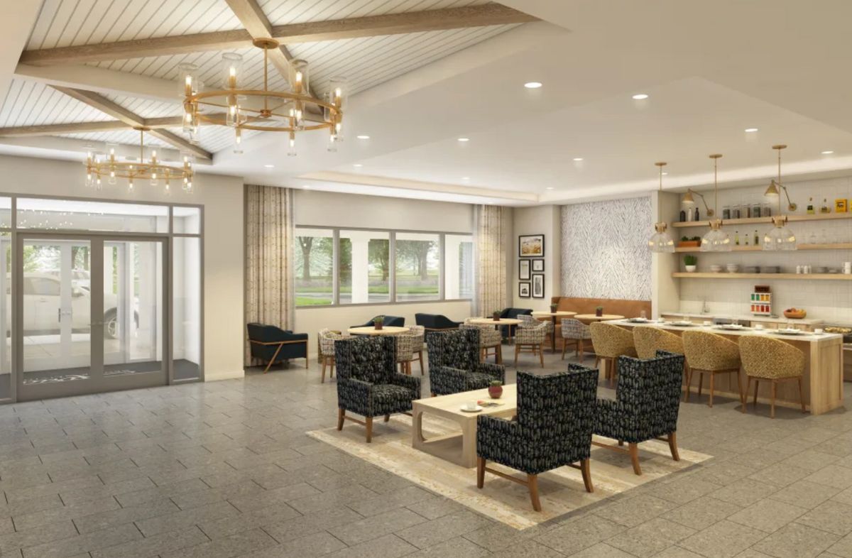 A modern lounge area with comfortable seating and elegant chandeliers.