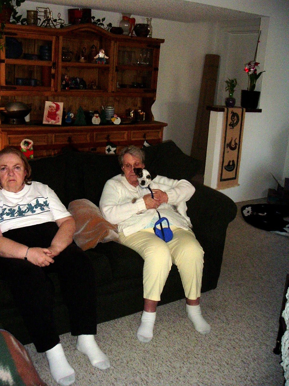 Two people relaxing on a couch in a living room setting.