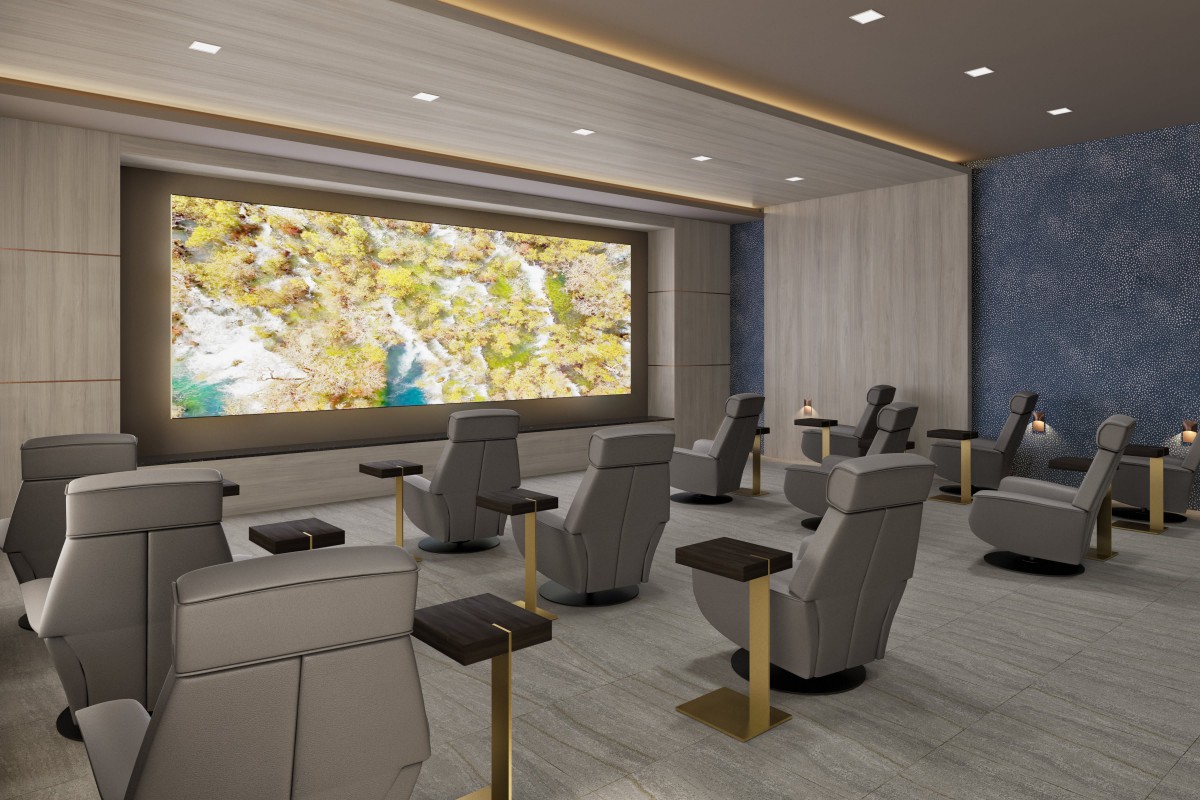 A modern home theater with luxury seating and a large screen.