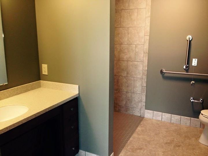 A modern bathroom with a walk-in shower and a countertop sink.