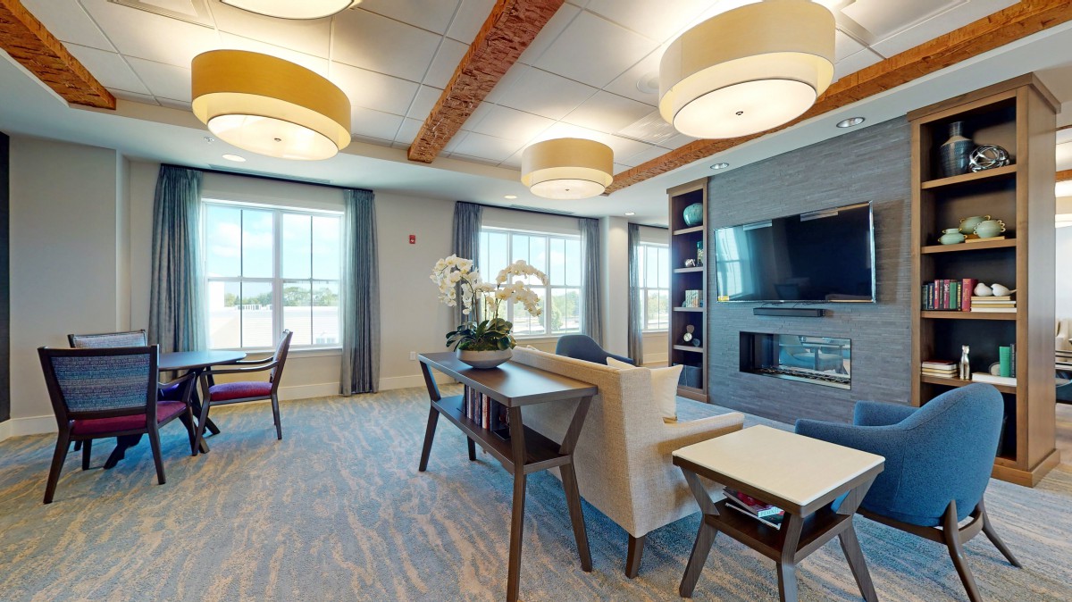 A modern living room with contemporary furniture, ample lighting, and a cozy atmosphere.