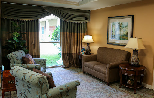 A cozy living room featuring elegant curtains, a comfortable sofa, and tasteful decor.