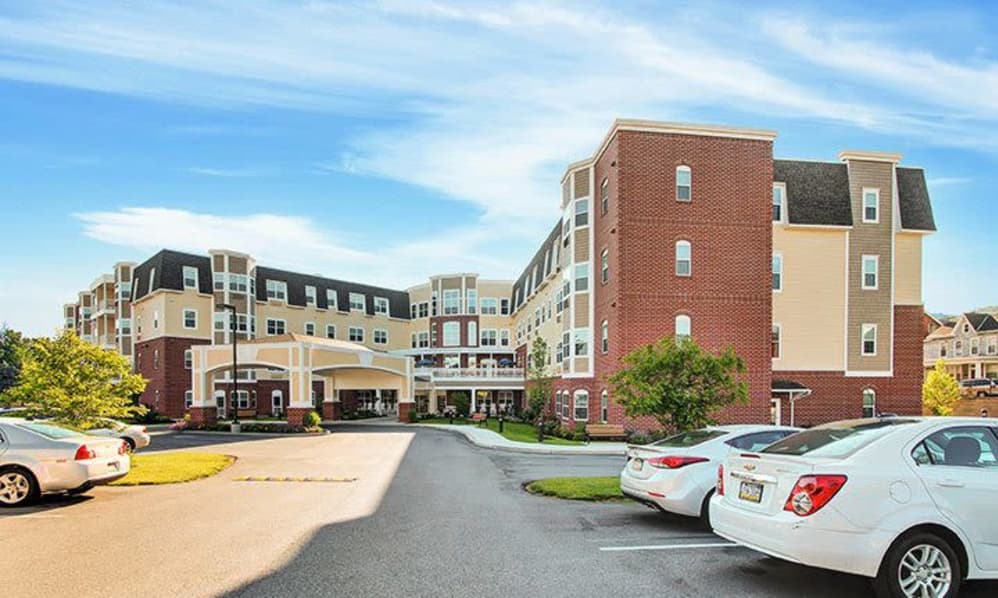 A modern medical facility with a parking lot in front.