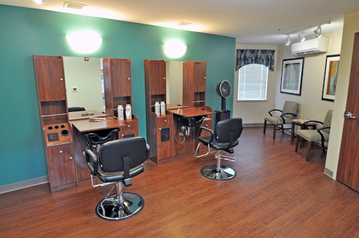 A well-organized hair salon featuring stylish chairs and mirrors, perfect for hair styling services.