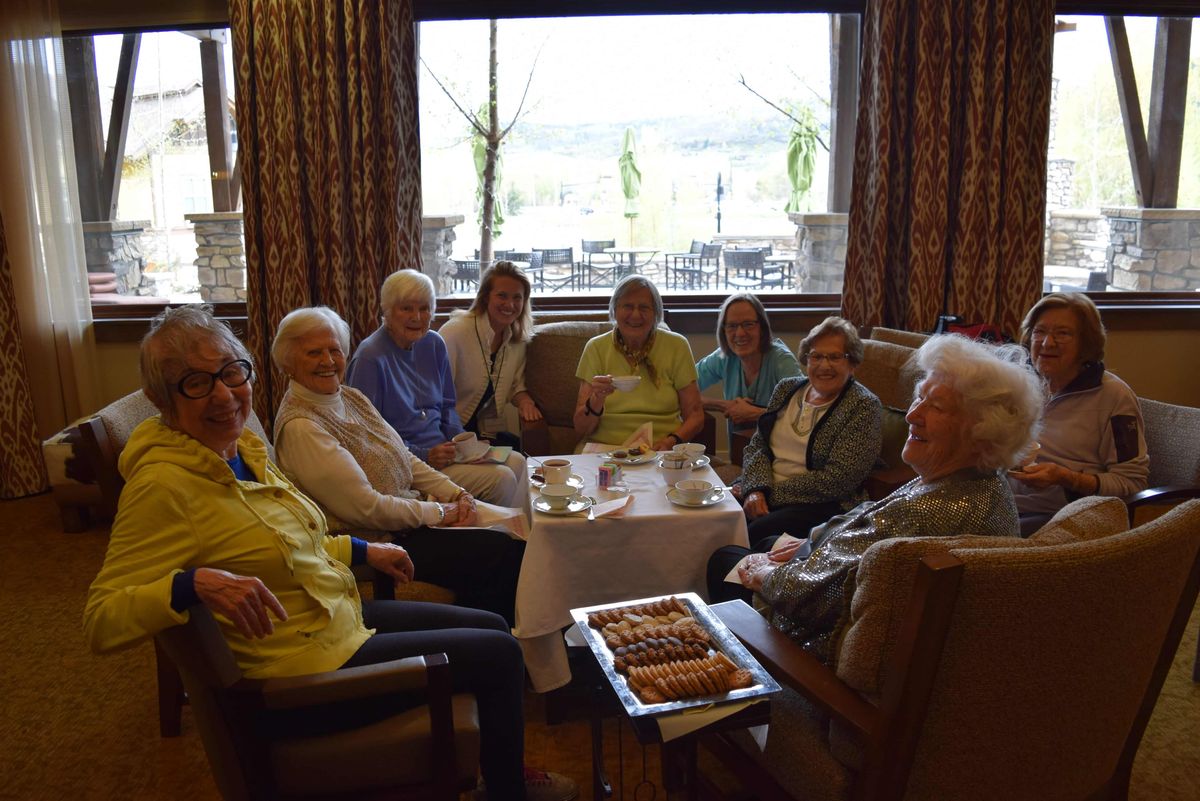 A group of seniors socializing in a cozy indoor setting.