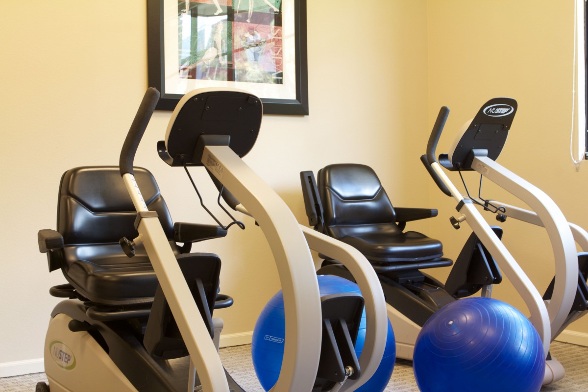 A small indoor gym with exercise bikes and fitness balls.
