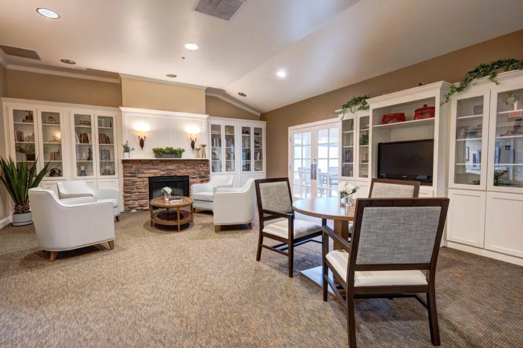 A spacious and elegantly designed living room with a cozy seating area, fireplace, and modern furniture.
