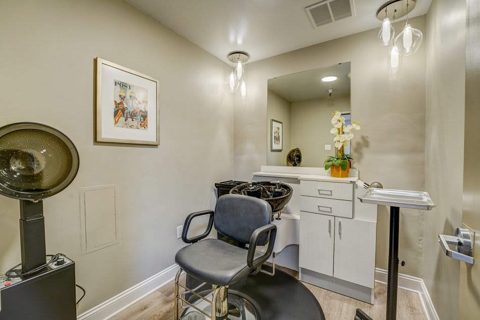 A modern hair salon with a comfortable barber chair, stylish decor, and well-lit interior.
