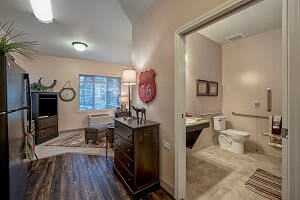 A view of a well-furnished bedroom with an adjoining bathroom.