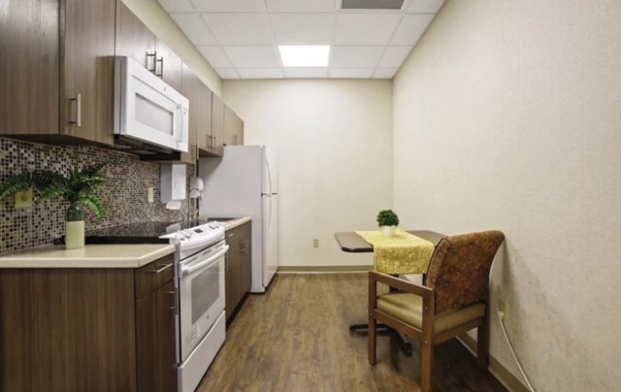 A compact kitchen area with modern appliances and a small dining table.