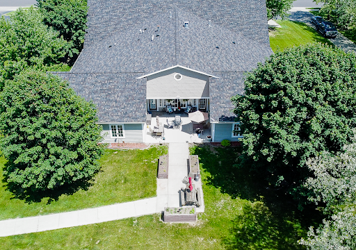 Aerial view of a spacious home with a well-maintained garden and walkway.