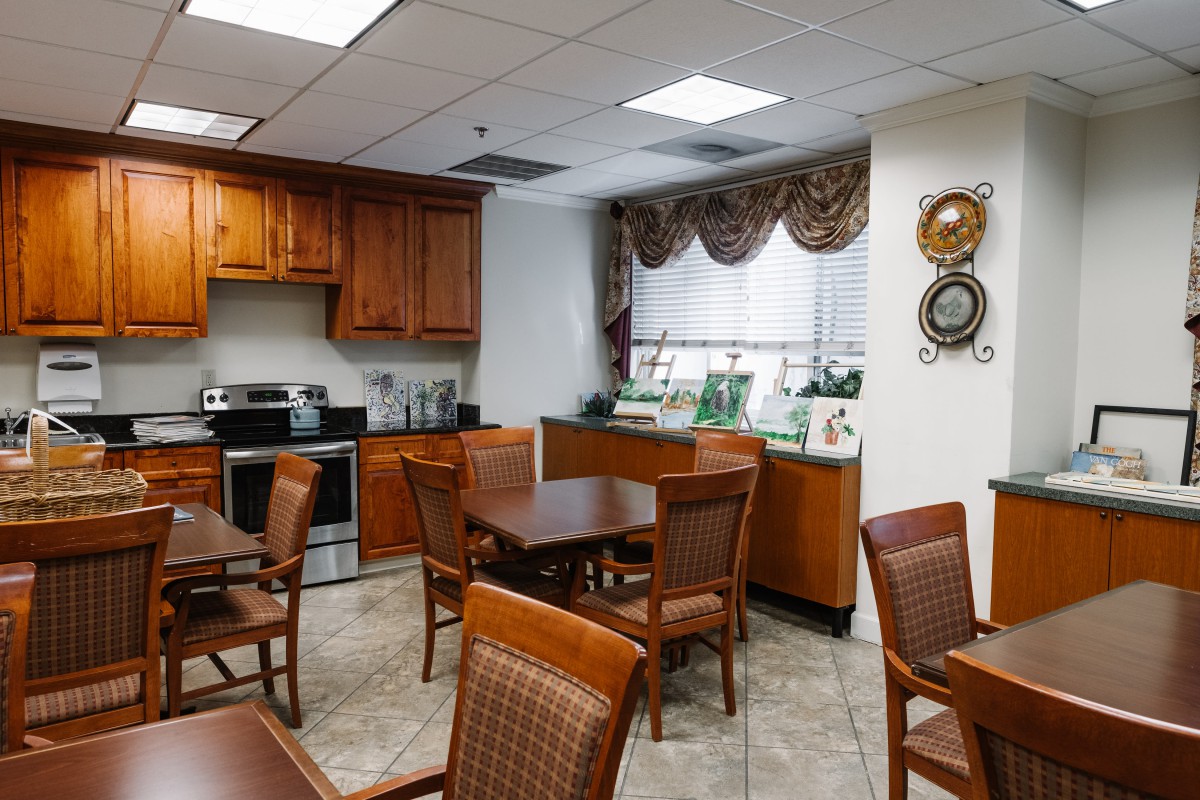 A cozy kitchen and dining area featuring wooden furniture and modern appliances.