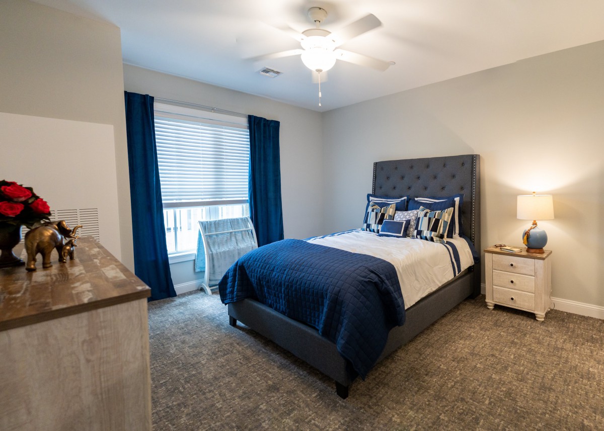 A cozy bedroom with modern furnishings and blue accents.