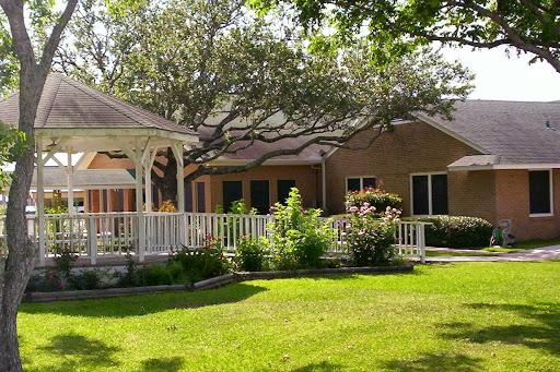 A charming house surrounded by lush greenery and a well-maintained garden.