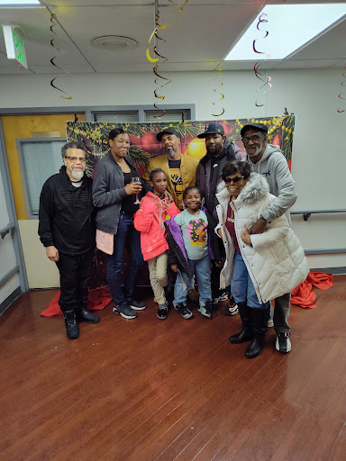A joyful group poses together during a celebration.