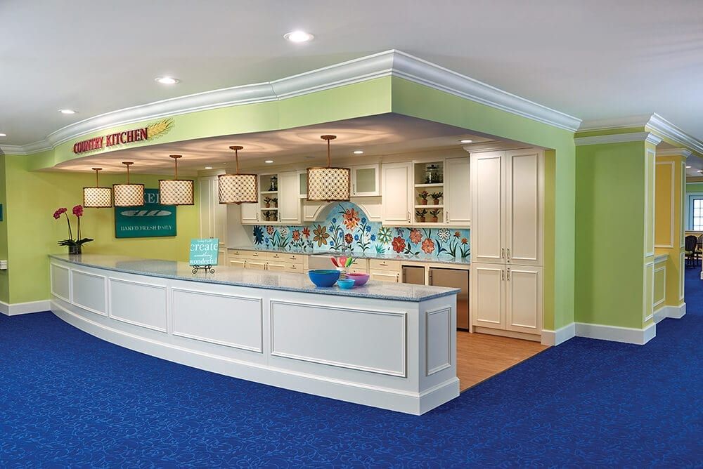 A modern and colorful kitchen with a spacious counter area and bright lighting.
