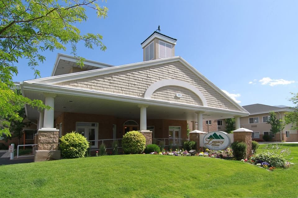 A well-maintained residential building with neatly landscaped surroundings and a prominent entrance.