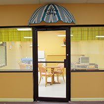 A cozy caf interior with a closed glass door displaying the sign 'The Caf'.