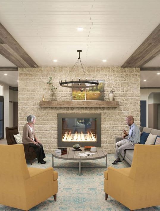 A cozy living room with a modern fireplace and comfortable seating.