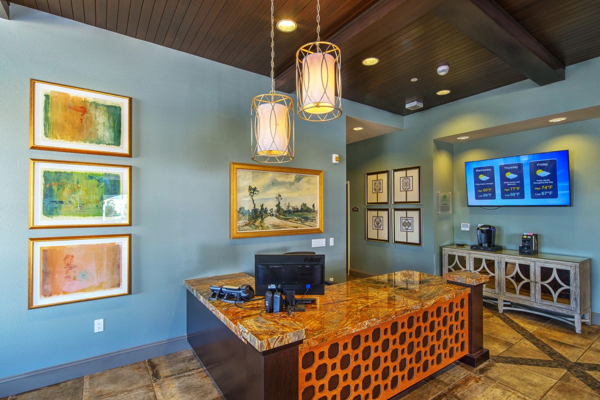 A modern reception area with stylish decor and a computer on the desk.