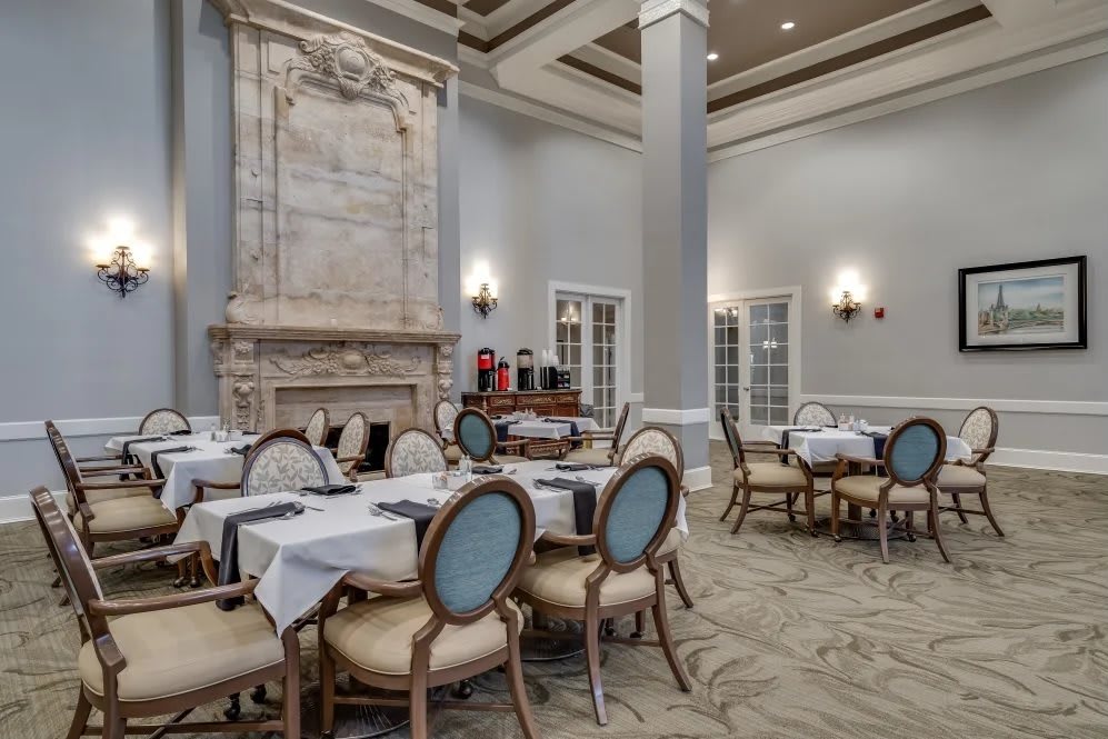 An elegant dining room with beautifully set tables and classic decor.