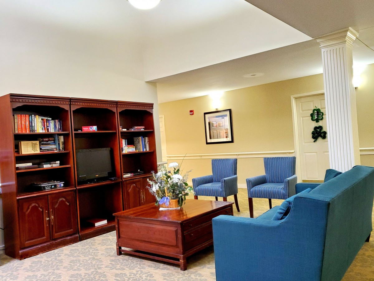 A cozy living room featuring a bookshelf, television, and comfortable seating.