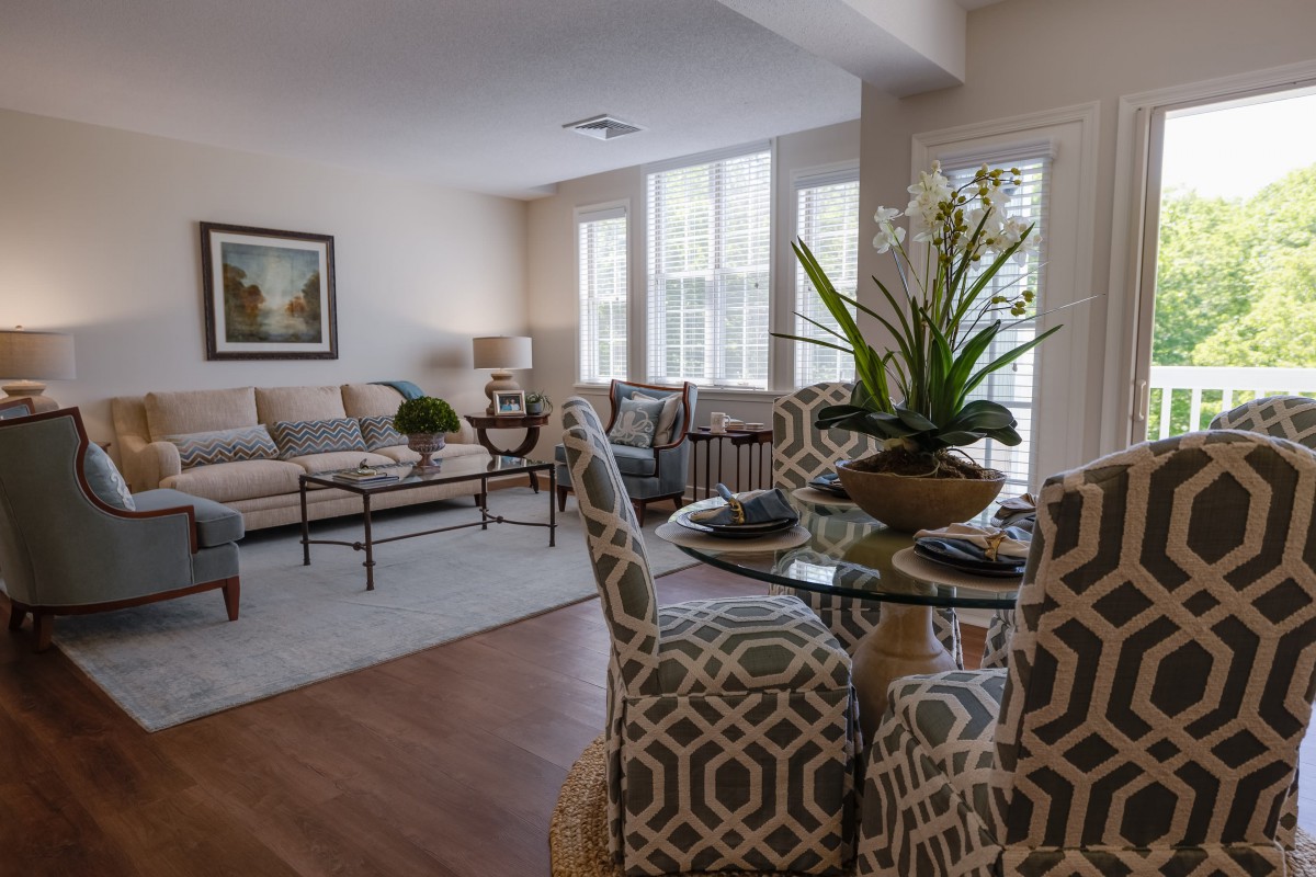 A modern living and dining area with stylish decor and bright natural lighting.