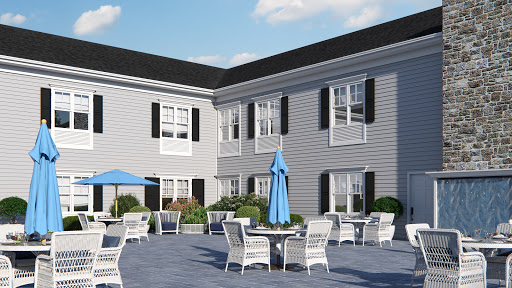 A serene courtyard area featuring outdoor seating and tables, perfect for relaxation.