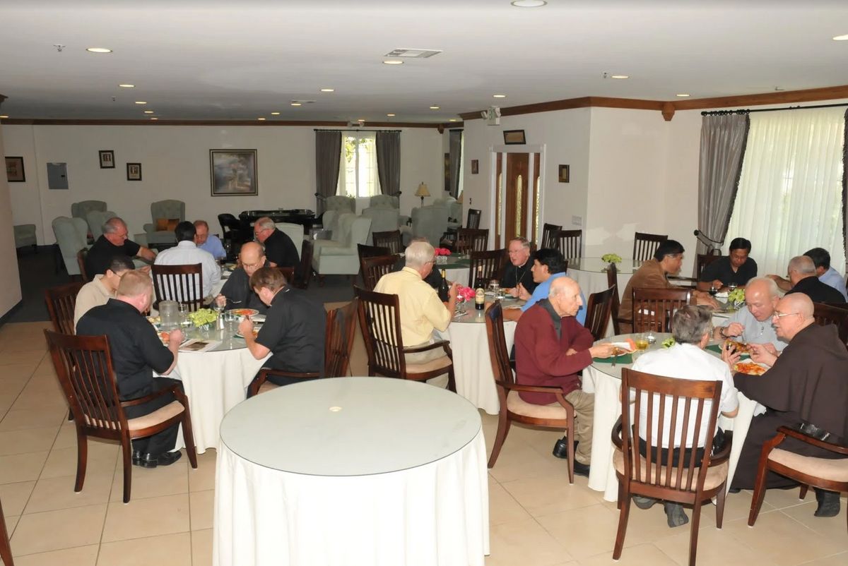 A group of people dining together in an indoor setting.