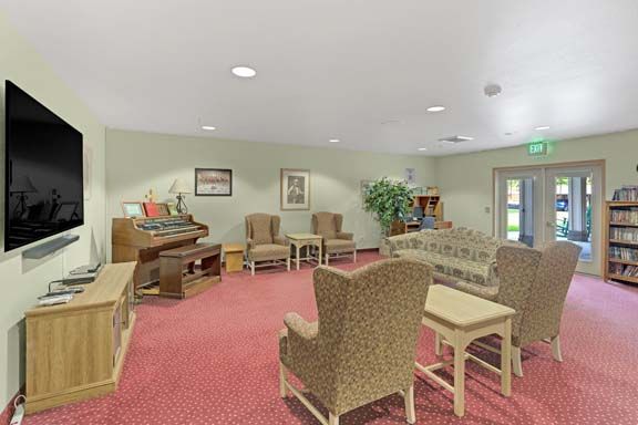 A comfortable living room with ample seating, an organ, and tasteful decor.