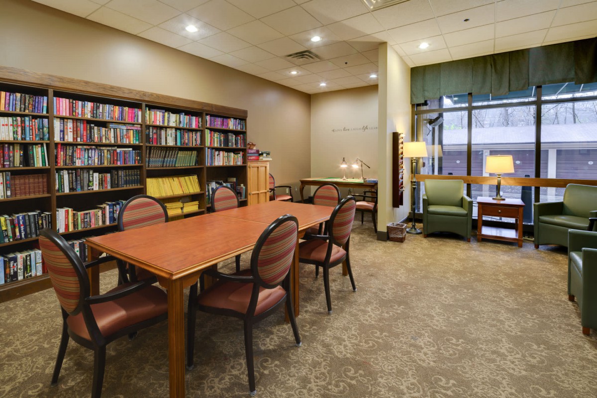 A cozy library reading area with a bookshelf and seating.