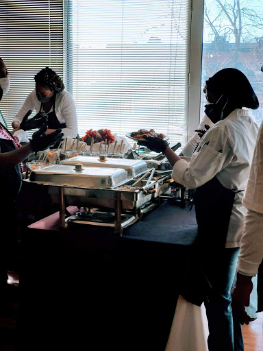 Catering staff serving food at an event.