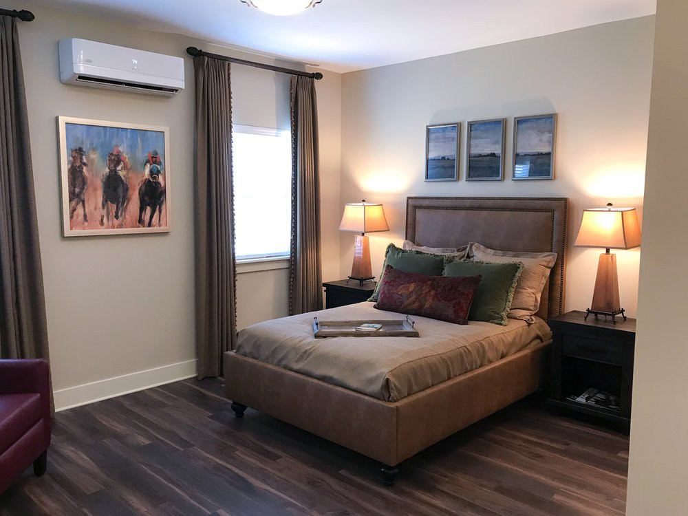 A cozy bedroom with a plush bed, nightstands, and decorative artwork.