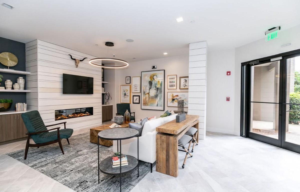 A stylish and modern living room featuring contemporary furniture, wall art, and sleek decor.